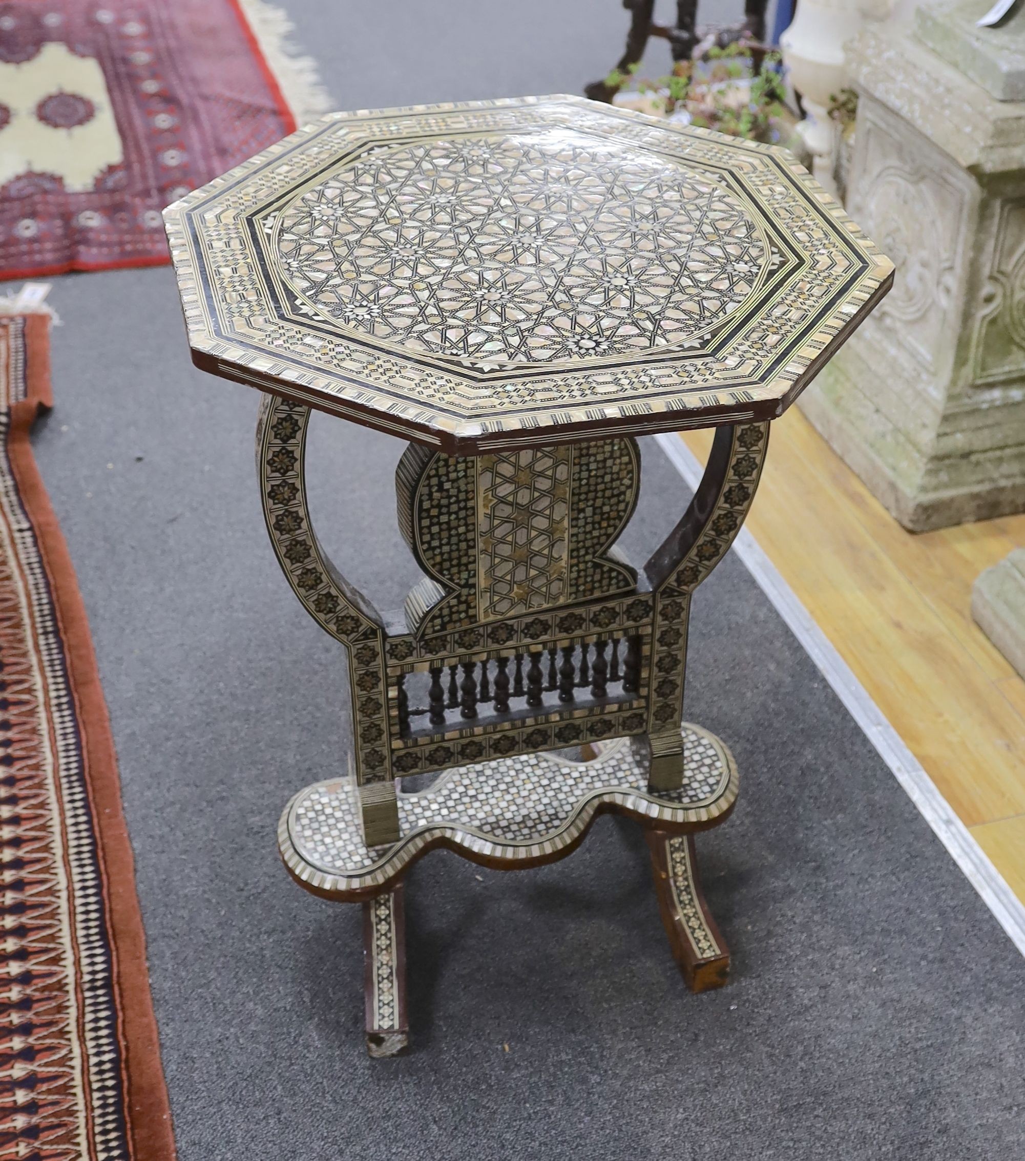 A Damascusware and mother of pearl inlaid octagonal tilt top table, width 50cm, height 66cm